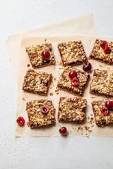 Cherry oatmeal crumble bars. Backed cherry crisp. Quick and easy homemade sweet red berry squares with streusel. Crumble fruit cake or pie. Wholesome and healthy breakfast. Home cooking. Top view.