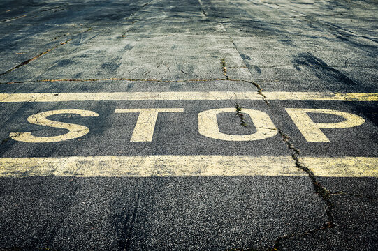 The inscription stop on an asphalt road.