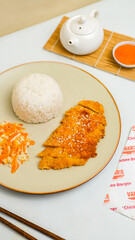 Chicken katsu served with rice and sauce, crispy on the outside and tender inside. A popular Japanese dish perfect for restaurant menus or food photography.
