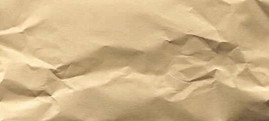 Wrinkled kraft brown paper background with copy space for creative design. Crumpled old brown vintage paper surface texture for background.