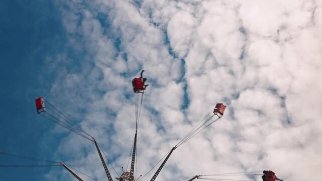 Low Angle View of Spinning Sky Swinger Ride at Fair