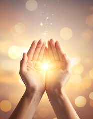 Magical dust of light shining in open hands.