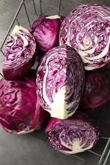 Fototapeta premium Whole and cut red cabbages on grey table, above view