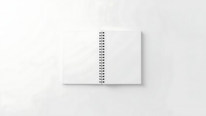 Minimalist white notebook with spiral binding and text on white background