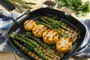 Delicious grilled vegetables with spices in pan on table, closeup