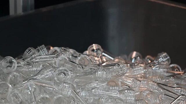 Slow motion scene the preform shape fall from injection mold.