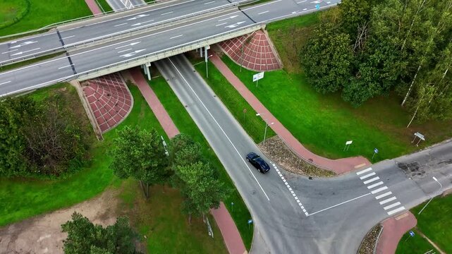 Aerial view of a modern road intersection and underpass in Ikskile, Latvia