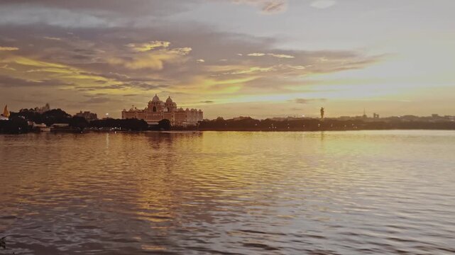 Hyderabad tank bund with telangana secretariat at golden hour. sun set time, static shot, 4k.
