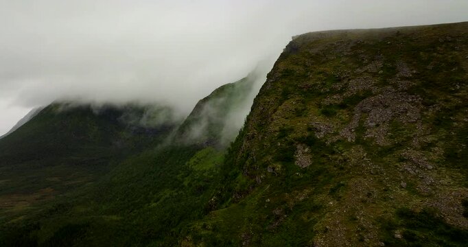 Mountains shrouded in mist and fog in Vester&aring;len, arctic landscape in northern Norway. Aerial drone view