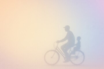 Obraz premium Father and Child Bicycle Silhouette on Pastel Gradient