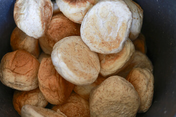 Close up of fresh palmyra fruit, tropical harvest in bucket. This exotic toddy palm, or ice apple, raw natural food from Asia, shows its fibrous husk and texture