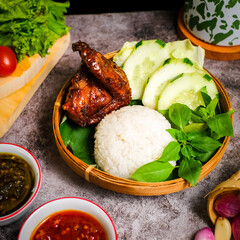 Grilled chicken breast with sweet and spicy seasoning, served with rice and sambal. Traditional Indonesian dish with smoky aroma and tender texture, perfect for food photography.