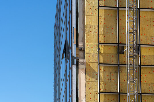 Exterior wall heat insulation with mineral wool, installing windows. Installing glazed ventilated facade on external wall. Building renovation, heat improvement. Minsk, Belarus - August 14, 2025