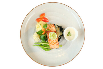 A gourmet salmon dish exquisitely presented on a white plate, ready to be enjoyed