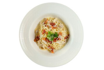 Delicious spaghetti carbonara served on a white plate. This classic pasta dish features a creamy sauce and is garnished with fresh parsley