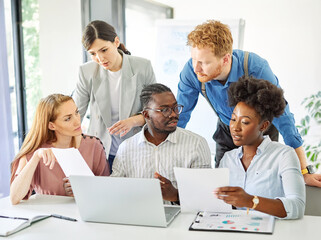 Fototapeta premium Group of young business people using laptop having a meeting or presentation and seminar in the office