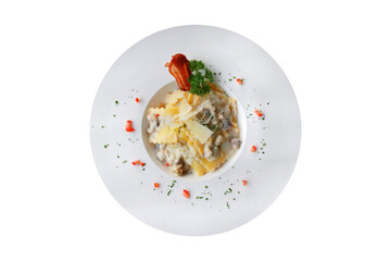 A top-down shot of a delicious pasta dish on a white plate, garnished with cheese and herbs