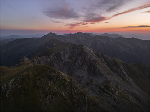 Aerial view of rugged peaks painted with the fiery hues of sunset, creating a breathtaking panorama of nature's artistry, Bucharest, Romania.