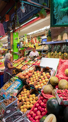 Fototapeta premium Indoor fruit and vegetable stall at the Andalusian market located at the entrance in the historic district across the Guadalquivir River in Mercado de Triana, Seville, Andalusia, Spain