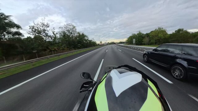 Perak, Malaysia - February 25, 2025 Top view of motorcyclist on the highway