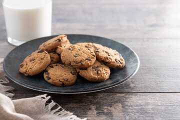 Chocolate chip cookies and milk for breakfast on rustic wooden table