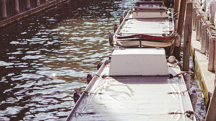 Traditional gondola near old houses in bright daylight in Venice © Наталья Добровольска