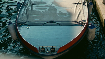 Traditional gondola near old houses in bright daylight in Venice © Наталья Добровольска