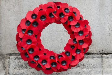 Naklejka na ściany i meble Remembrance Day Poppy Wreath Mounted on Wall. World War remembrance day.