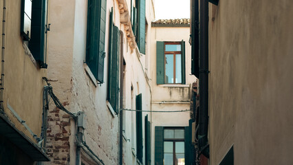 Ancient Venetian buildings close together reflecting in canal water