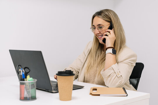 woman working in the office answering the phone