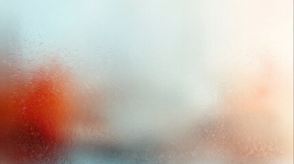 Dewdrops on frosted glass create a blurry, abstract background with color hints.