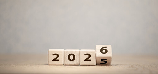 Wooden cubes changing year 2025 to 2026 on neutral background