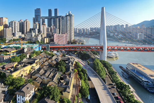 Aerial view of the river reflecting the sky, contrasting against the modern skyline and Huguang Guild Hall's ancient rooftops, Chongqing, China.