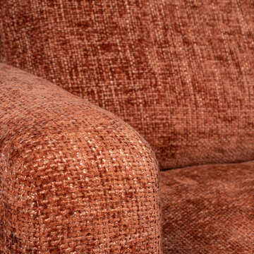 Detailed close-up of terracotta chenille sofa upholstery highlighting fabric weave, warm earth tones, and soft texture. Perfect for interior design, textile, or furniture craftsmanship concepts