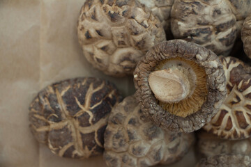 Dried shiitake mushrooms arranged in a close-up view, showcasing their intricate textures and earthy colors.