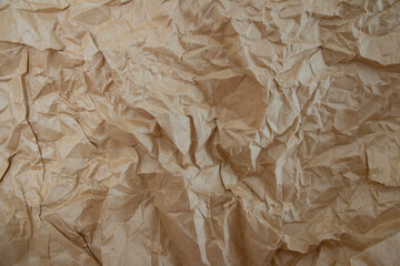 Textured brown crumpled paper background, showcasing intricate folds and creases, ideal for artistic or design applications.