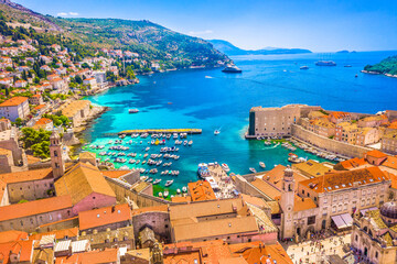 Drone image capturing the old town of Dubrovnik surrounded by ancient city walls, terracotta rooftops and the blue Adriatic Sea showing the beauty of the southern Croatia