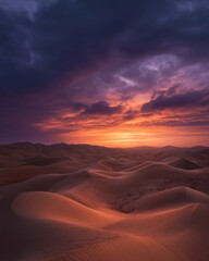Naklejka premium Dramatic sunset over the endless dunes creating a majestic landscape.
