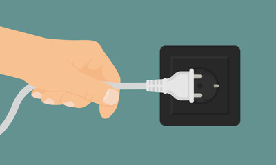 Hand gripping power cord and unplugging it from wall outlet. Electrical hazard concept