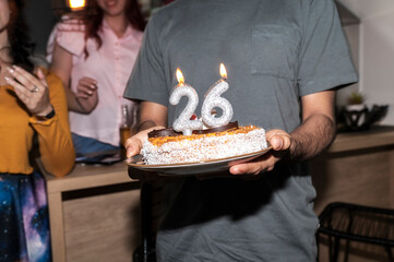 Close up of silver 26 New Year candles shining in cozy Christmas lights celebration