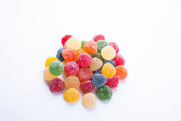colored jelly beans in different flavors on a white background