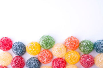 Sugar-coated jelly beans in different colors and flavors with copy space for advertising