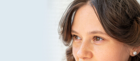 Smiling girl looking to side, eyes close up, vision examination, positive emotion, young woman 30 years portrait part, cheerful mood, natural beauty, Joy and happiness, Authentic Emotional Expression