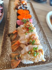 Shrimp sushi, otoro sushi, shrimp roe sushi, eel sushi on a tile tray