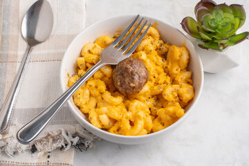 macaroni and cheese  with an italoan style meatball