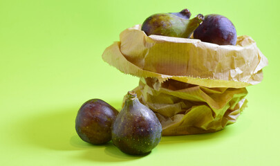 Close up, fresh figs on a green background.	
