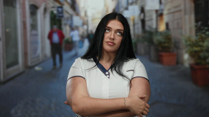 Fototapeta premium Woman with long hair and plus size figure standing confidently on a bustling city street outdoors exuding elegance and poise.