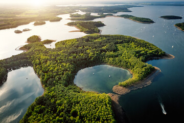 Islands and lakes surrounded by forest from above