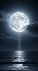 Full moon shining over a dark ocean at night. Moonbeam reflecting on water surface. Mystical night landscape for astronomy and nature concepts.