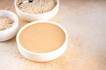 Tahini with sesame seeds, oily sesame paste, source of healthy fats, snack or ingredient in Middle Eastern and Mediterranean foods